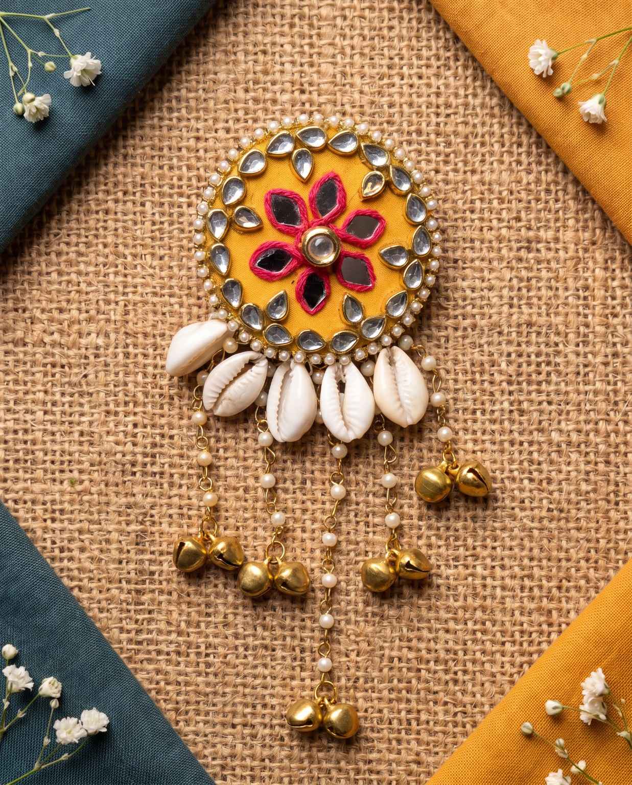 Kanak mustard yellow cowrie hair brooch with mirror work, pearl detailing and golden bells