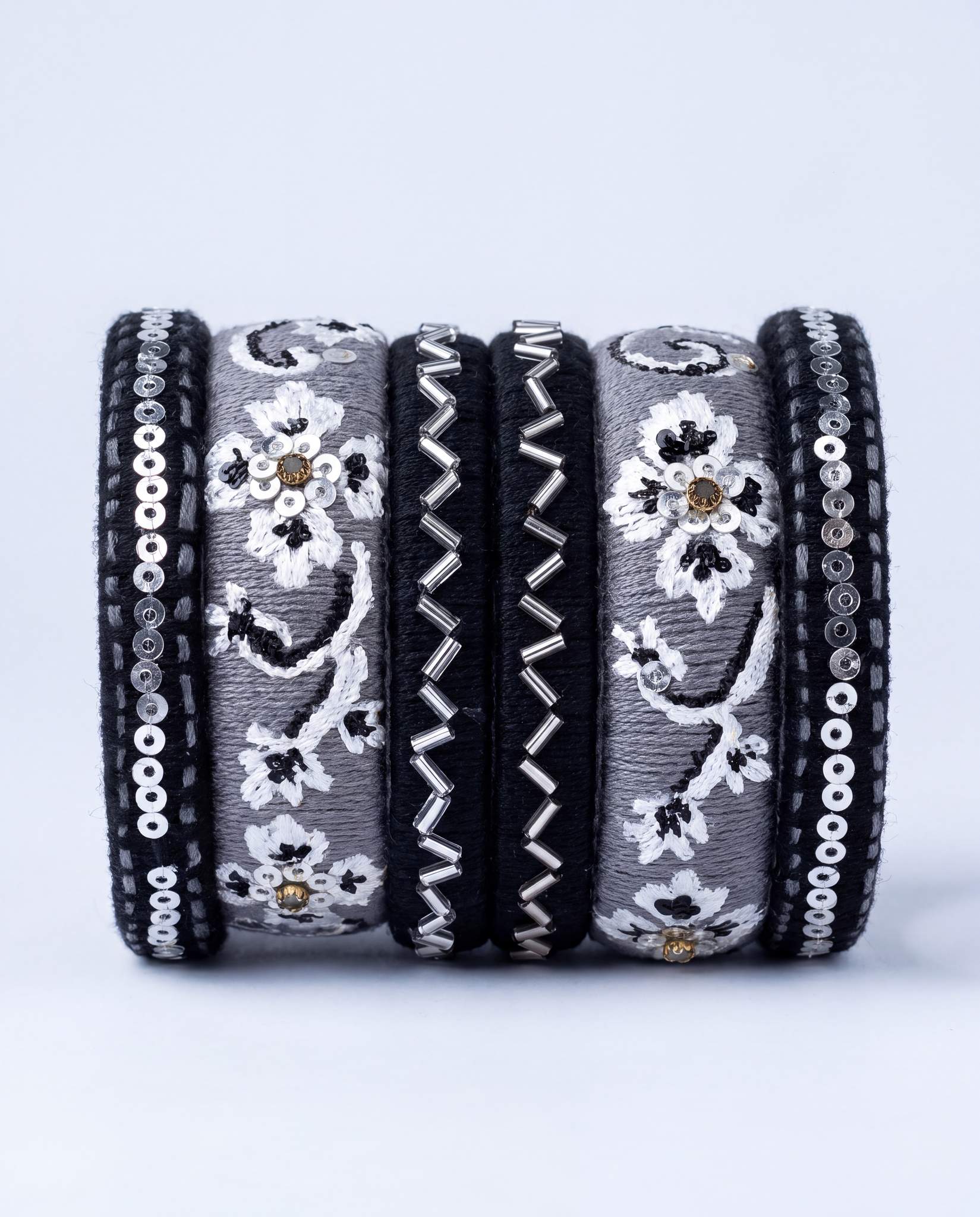 Black and grey silk thread bangle set with white floral embroidery and silver sequins