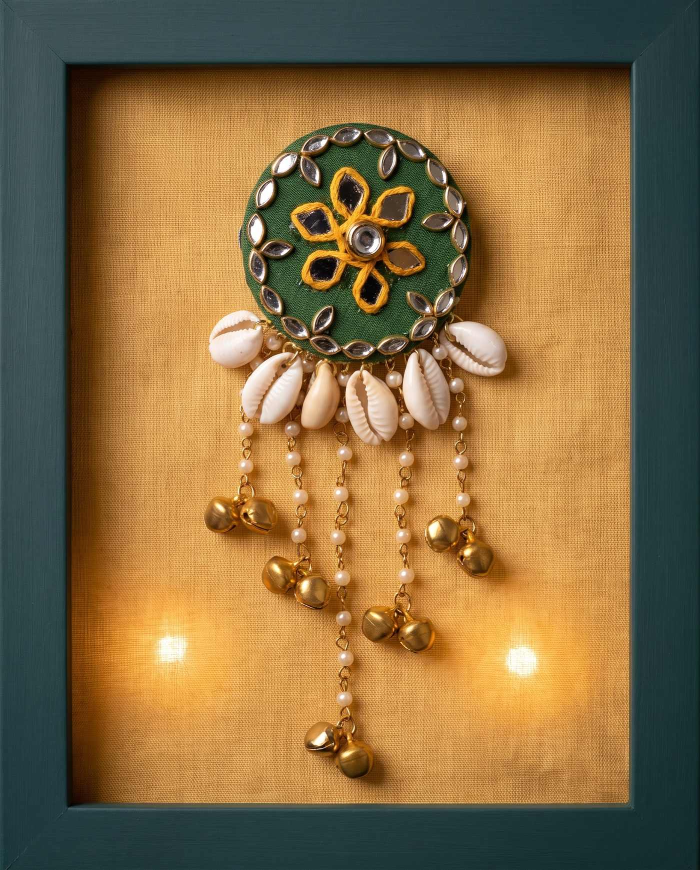 Green mirror hair brooch displayed in a framed shadow box with warm fairy lights