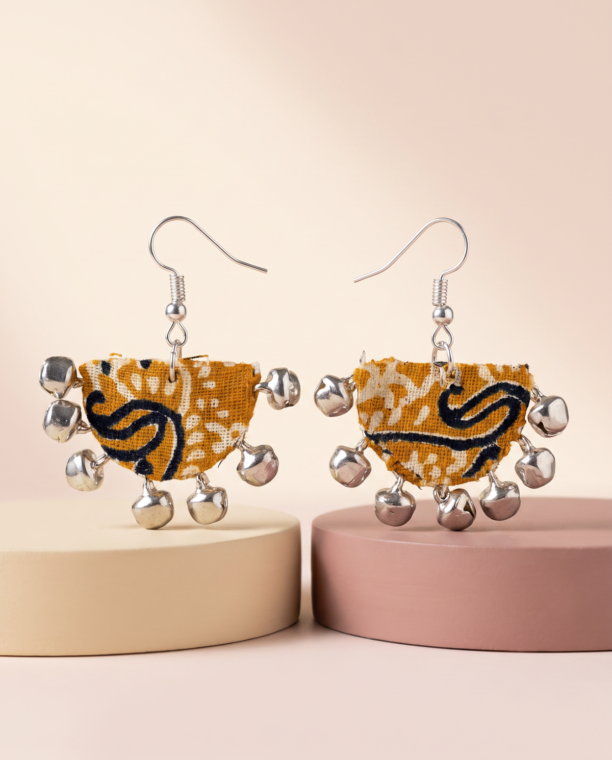 Handmade mustard, black & white paisley block-print fabric ghungroo dangle earrings by KEVILAGU with silver bell fringe