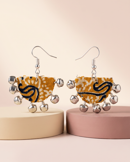 Handmade mustard, black & white paisley block-print fabric ghungroo dangle earrings by KEVILAGU with silver bell fringe
