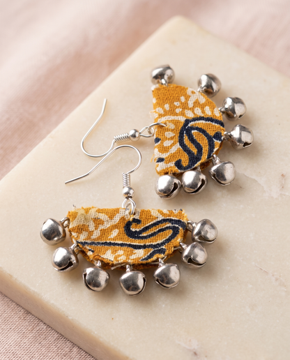Handmade mustard, black & white paisley block-print fabric ghungroo dangle earrings by KEVILAGU with silver bell fringe