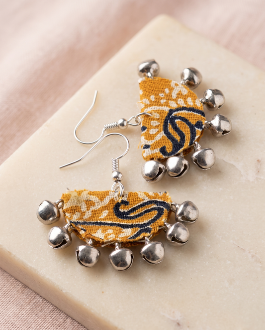 Handmade mustard, black & white paisley block-print fabric ghungroo dangle earrings by KEVILAGU with silver bell fringe