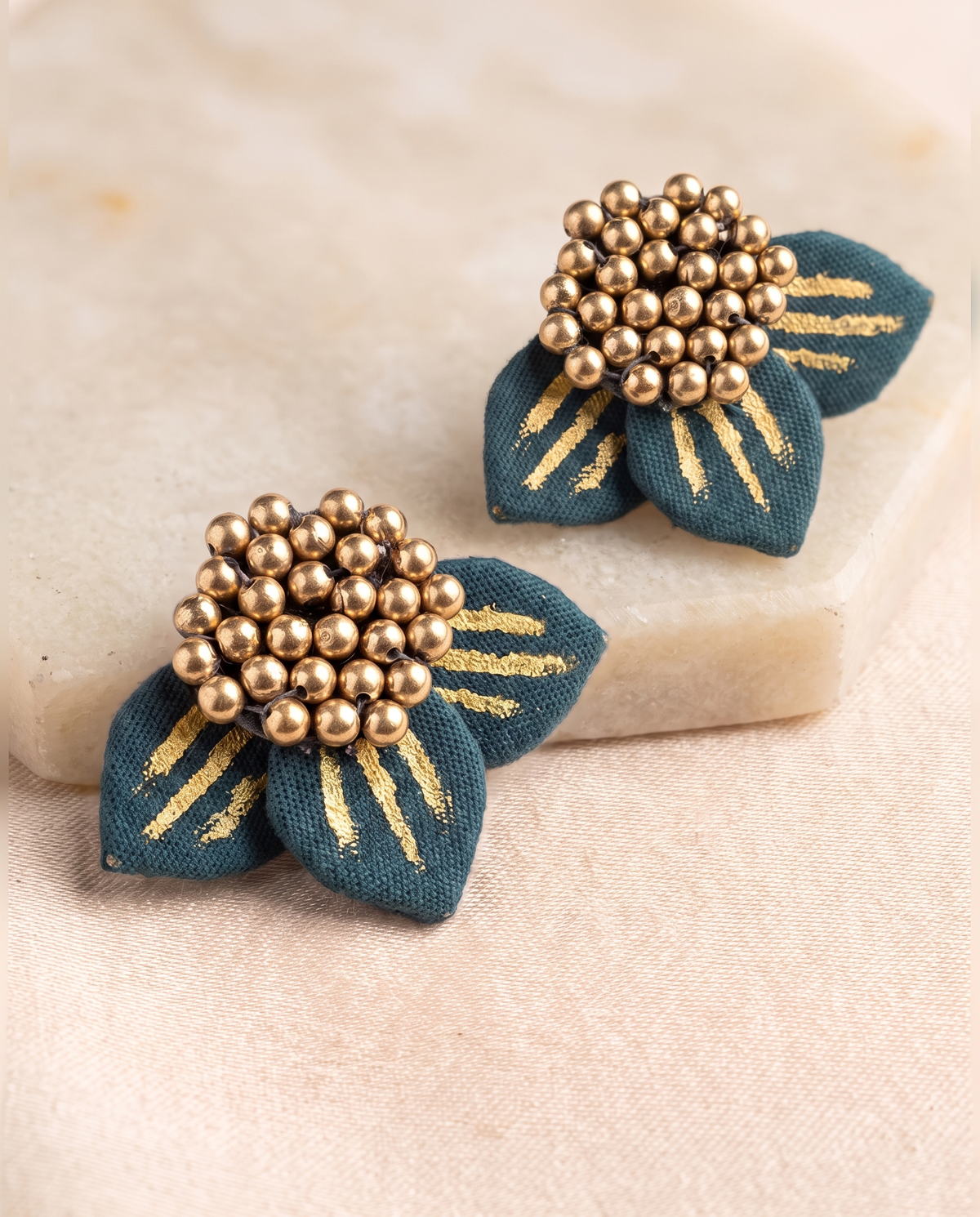 Handmade teal fabric floral stud earrings by KEVILAGU with gold bead detailing