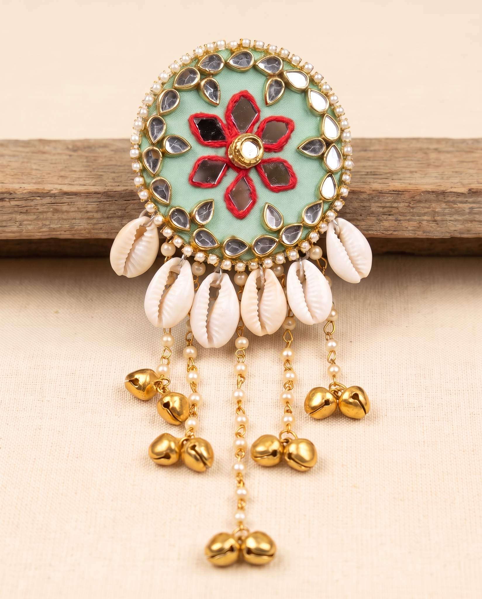 Mint green mirror work hair brooch with red floral embroidery and cowrie shell tassels