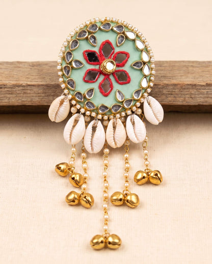Mint green mirror work hair brooch with red floral embroidery and cowrie shell tassels