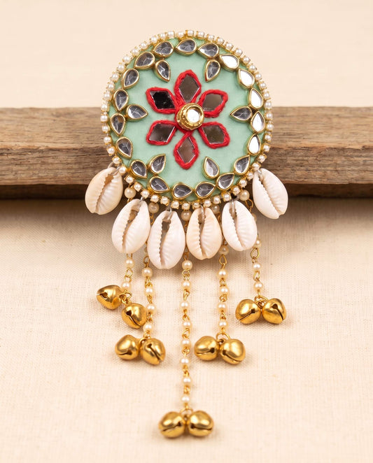 Mint green mirror work hair brooch with red floral embroidery and cowrie shell tassels