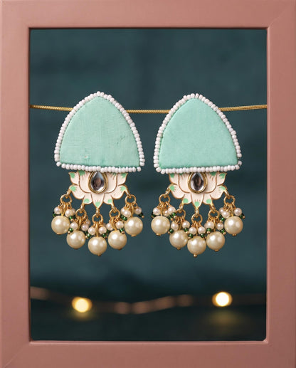 Mint green pearl floral earrings displayed in pink frame with fairy lights