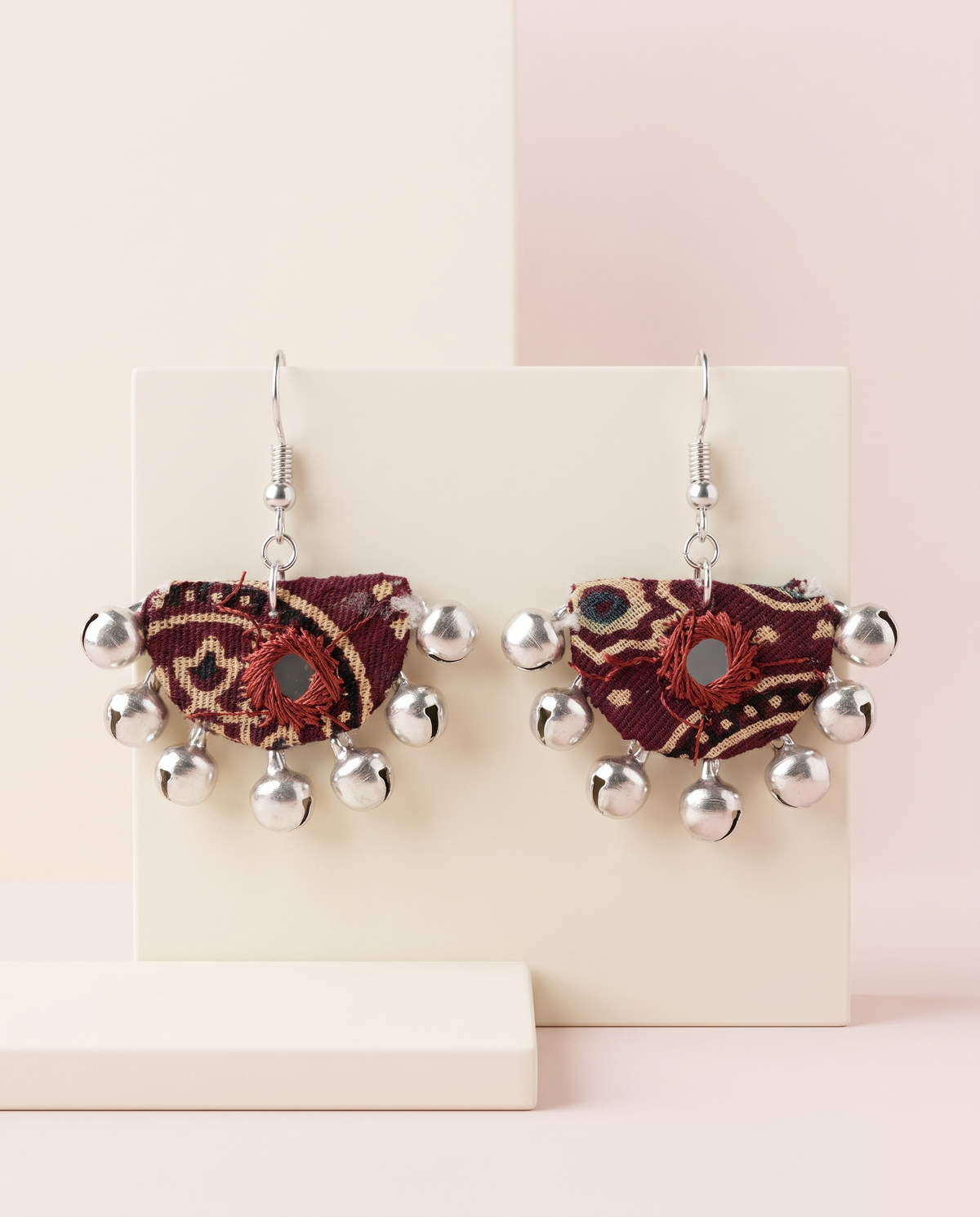 Handmade maroon & beige block-print fabric ghungroo dangle earrings by KEVILAGU with mirror-work accent and silver bell fringe