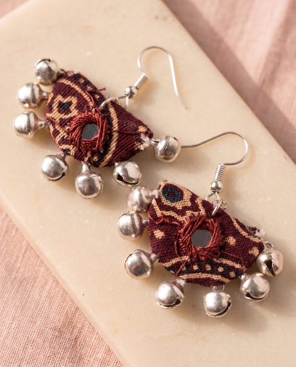 Handmade maroon & beige block-print fabric ghungroo dangle earrings by KEVILAGU with mirror-work accent and silver bell fringe