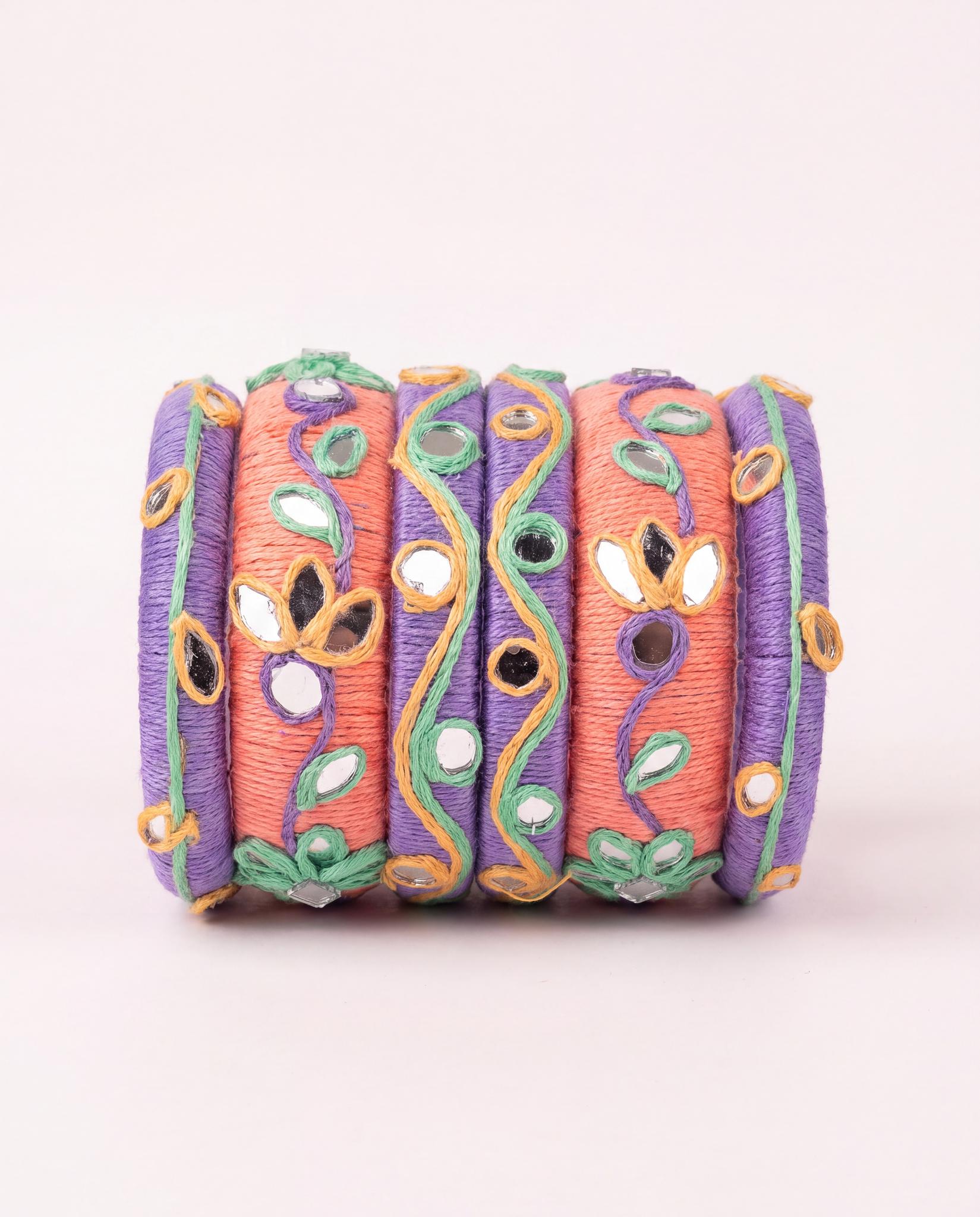 Peach and purple thread bangle stack with kundan mirror accents and embroidered vines