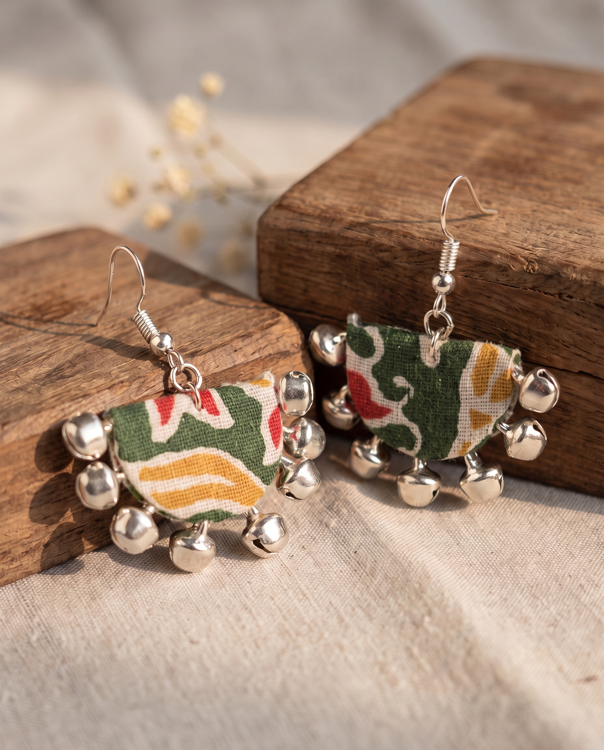 Handmade green, white, mustard & red multicolor block-print fabric ghungroo dangle earrings by KEVILAGU with silver bell fringe