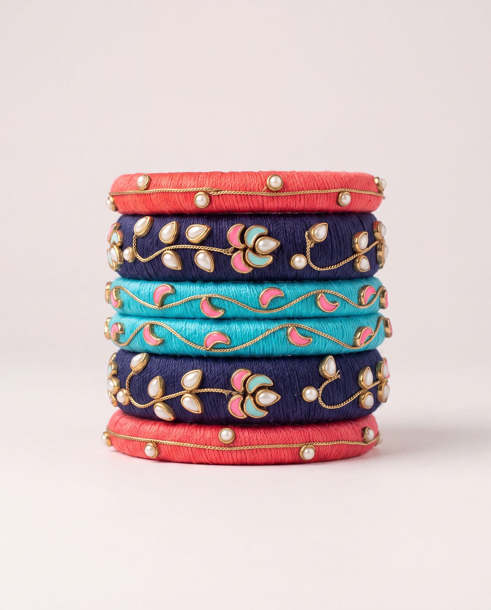 Red, navy, and turquoise silk thread bangle set with meenakari floral pearl detailing