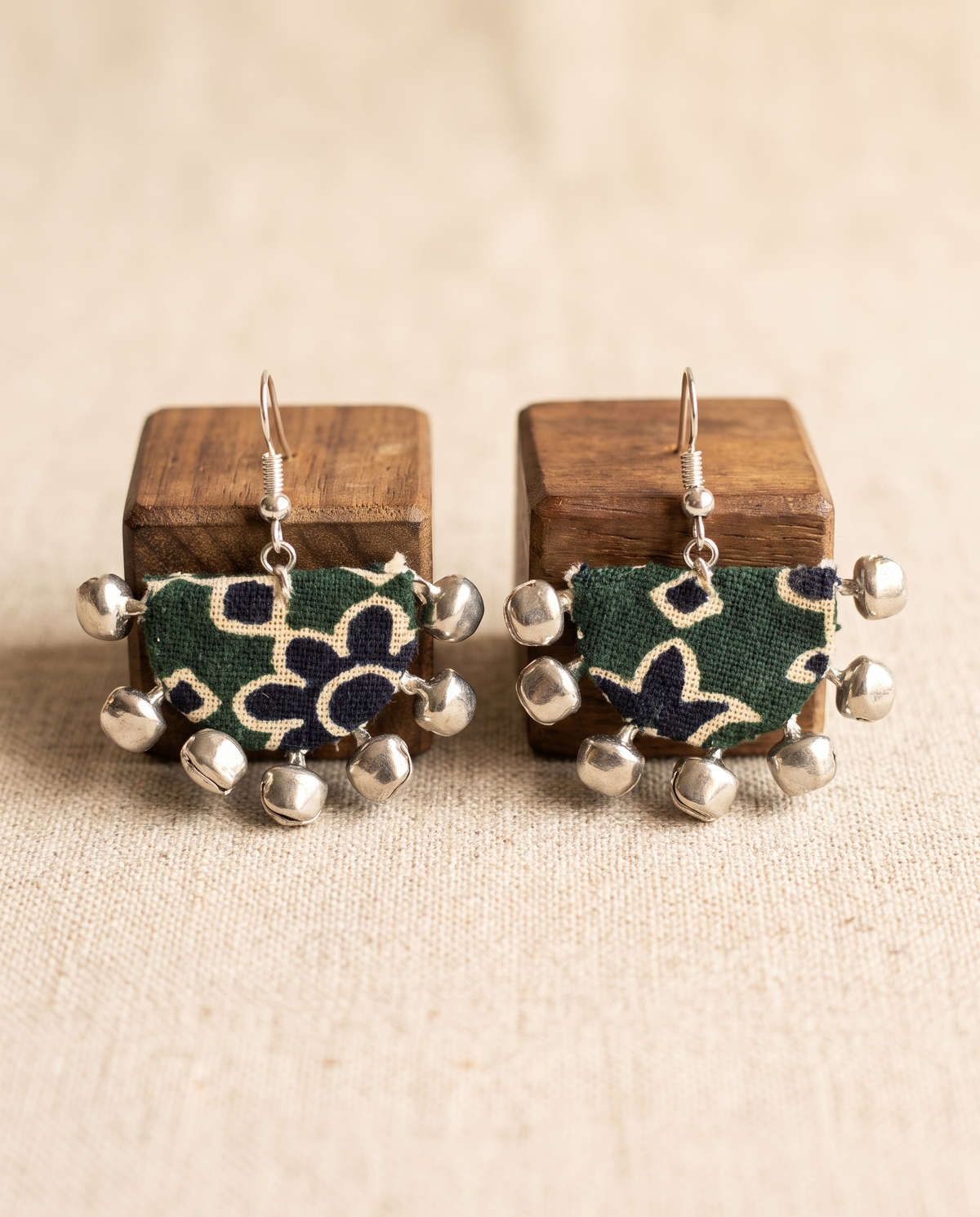 Handmade green, navy & beige block-print fabric ghungroo dangle earrings by KEVILAGU with silver bell fringe