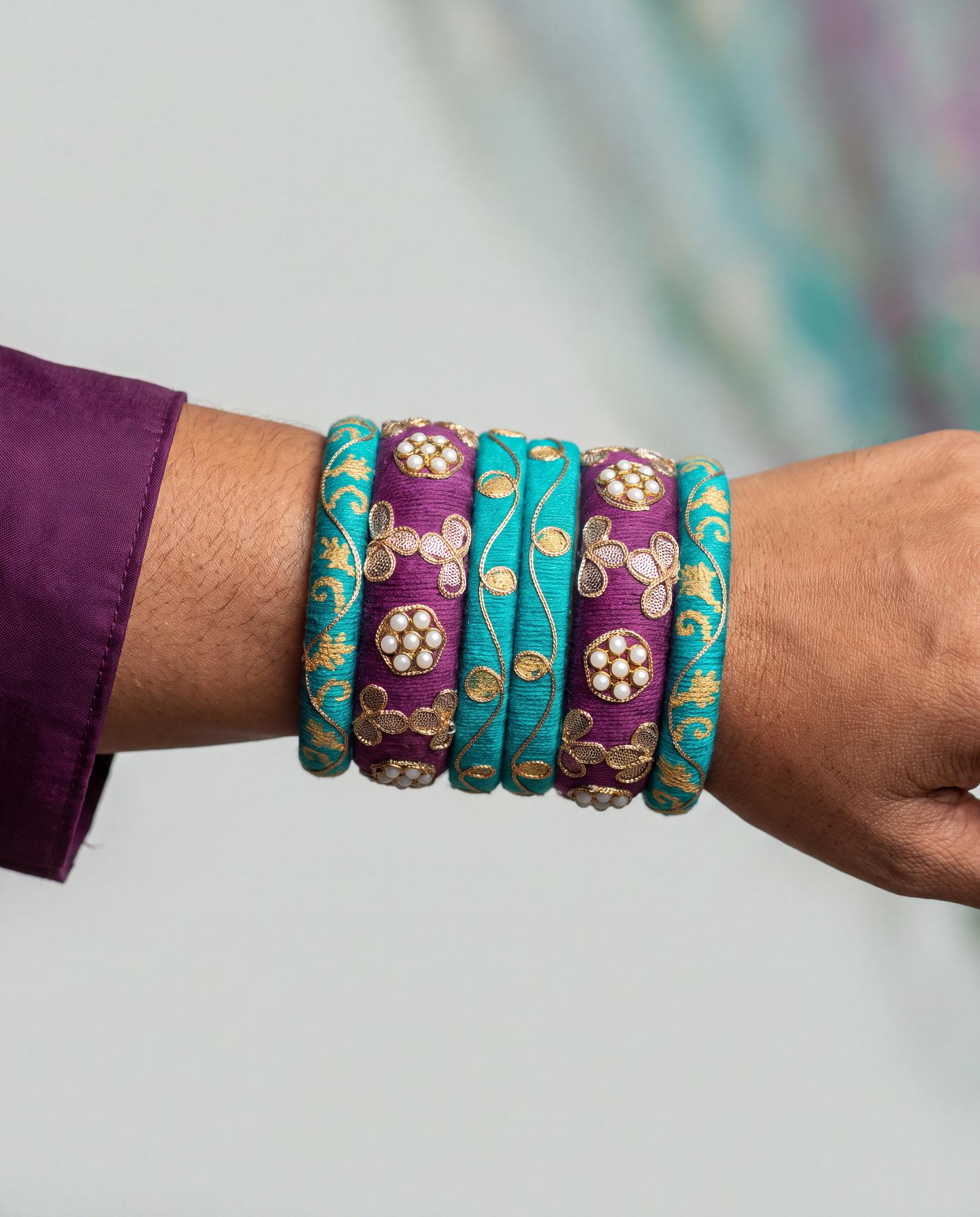 Woman wearing teal and plum silk thread zari kundan bangles stacked on wrist