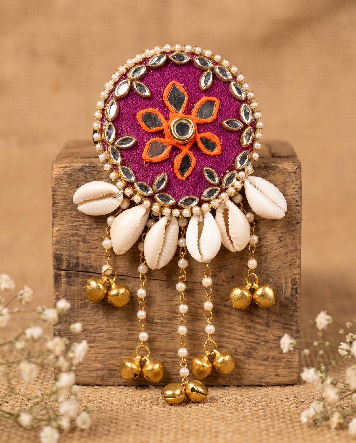 Handmade Rangili magenta mirror hair brooch displayed with cowrie shells and pearl embellishments