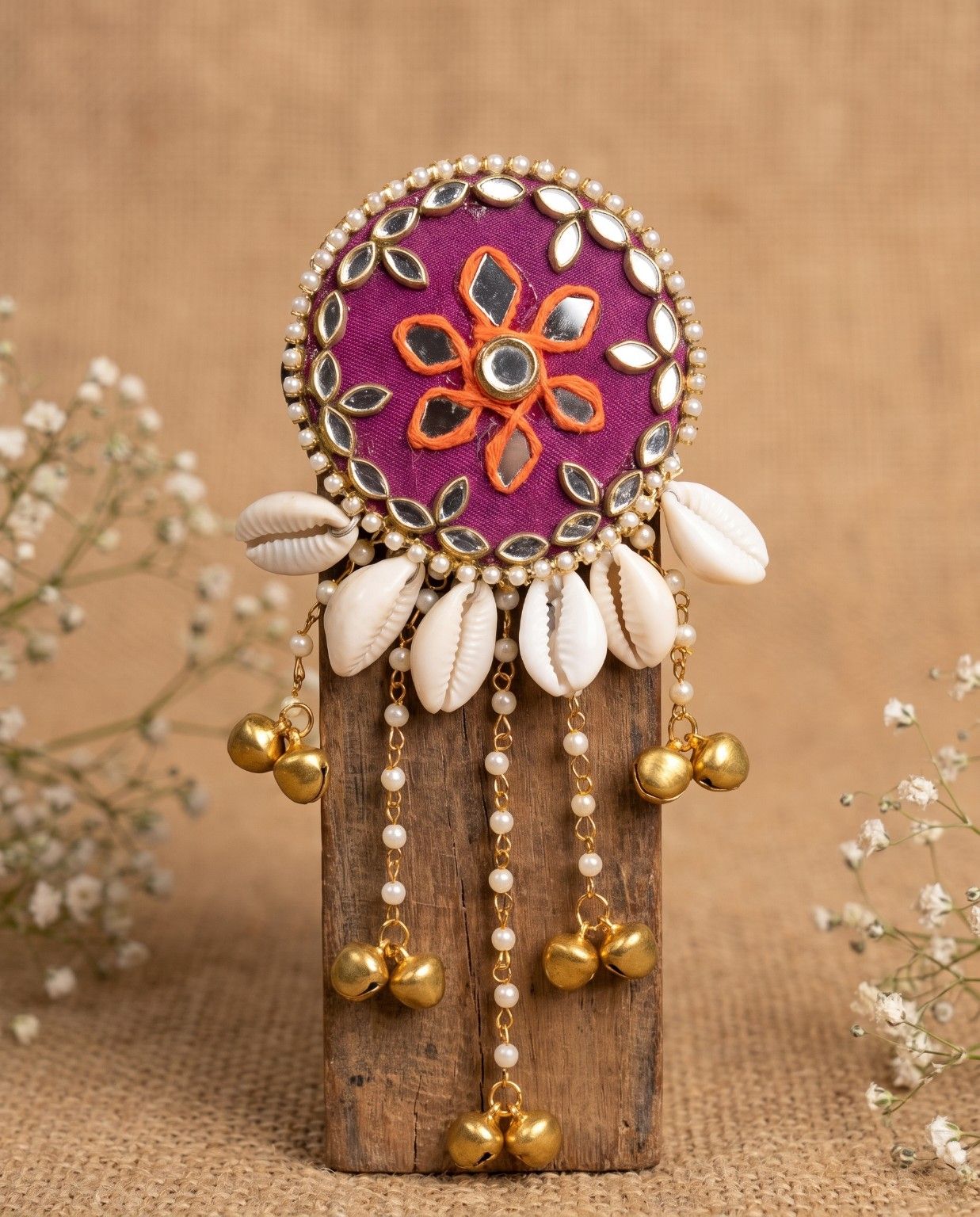 Rangili magenta hair brooch featuring cowrie shells, pearl chains and golden ghungroo