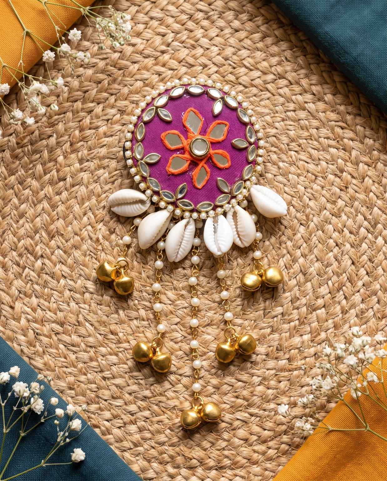 Rangili magenta cowrie shell hair brooch with mirror work, pearls and golden hanging bells